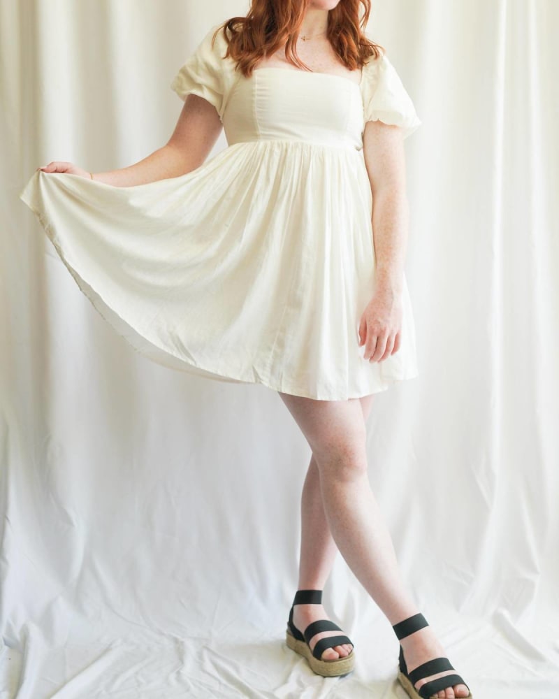 Front of a model wearing a size L Linen Babydoll Dress In White in White by MABLE. | dia_product_style_image_id:342279